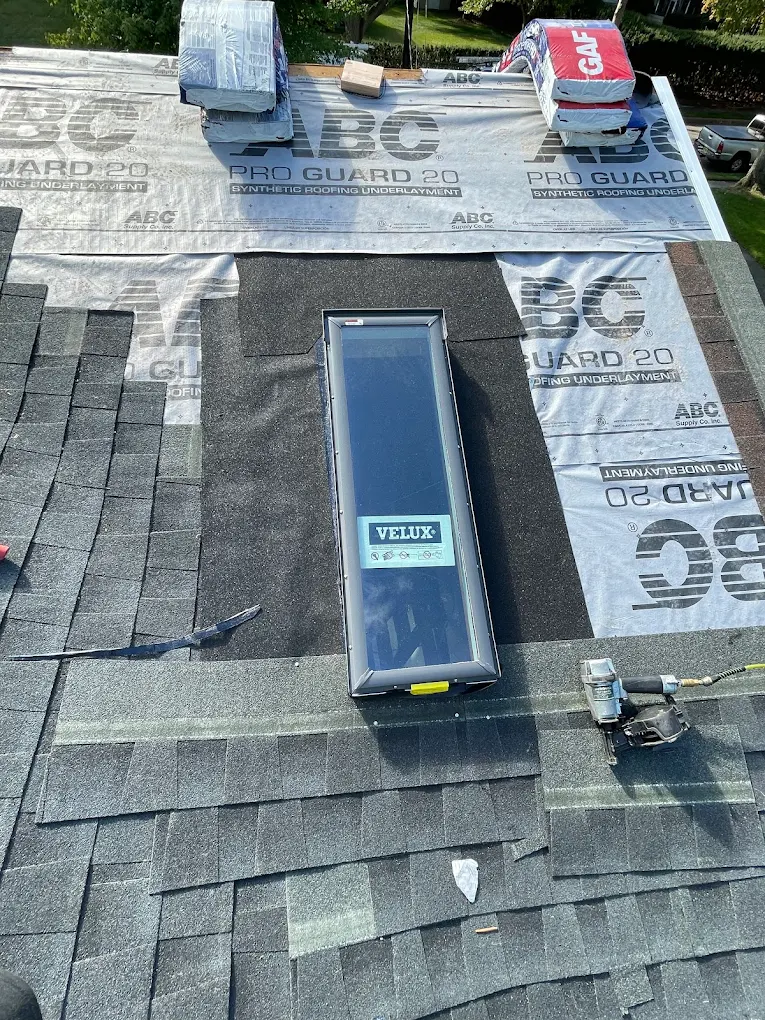 Skylight being flashed and detailed during a roof install
